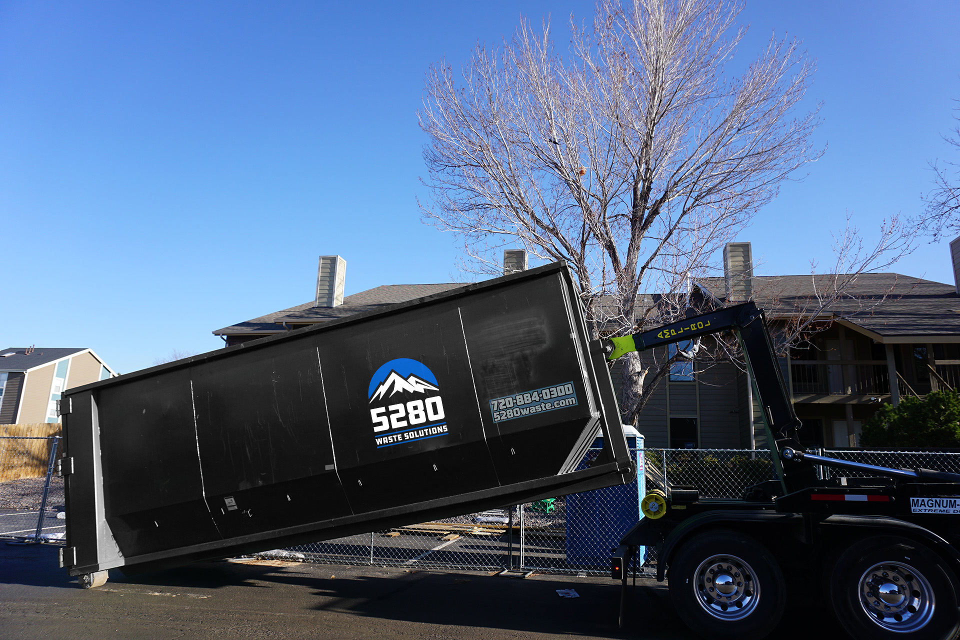Roll-off dumpster lined up for pickup outside Denver home, Roll-Off Dumpster in Westminster - CO positioned beside a driveway during a home renovation cleanup
