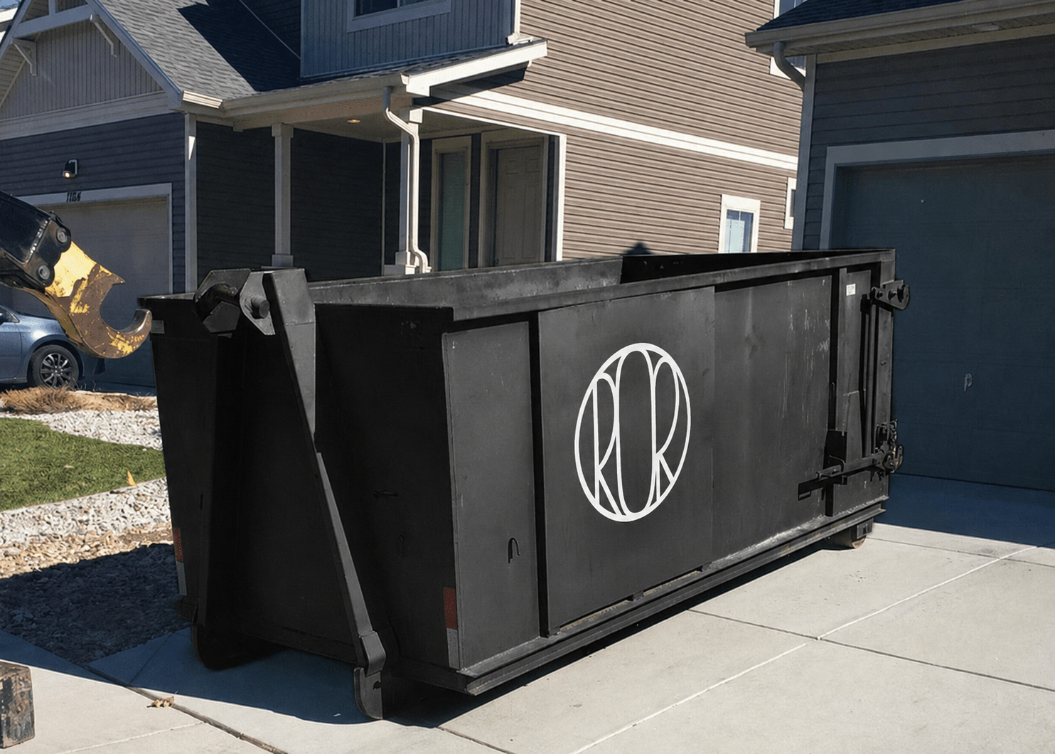 Roll-Off Dumpster in Federal Heights - CO positioned beside a driveway during a home renovation project