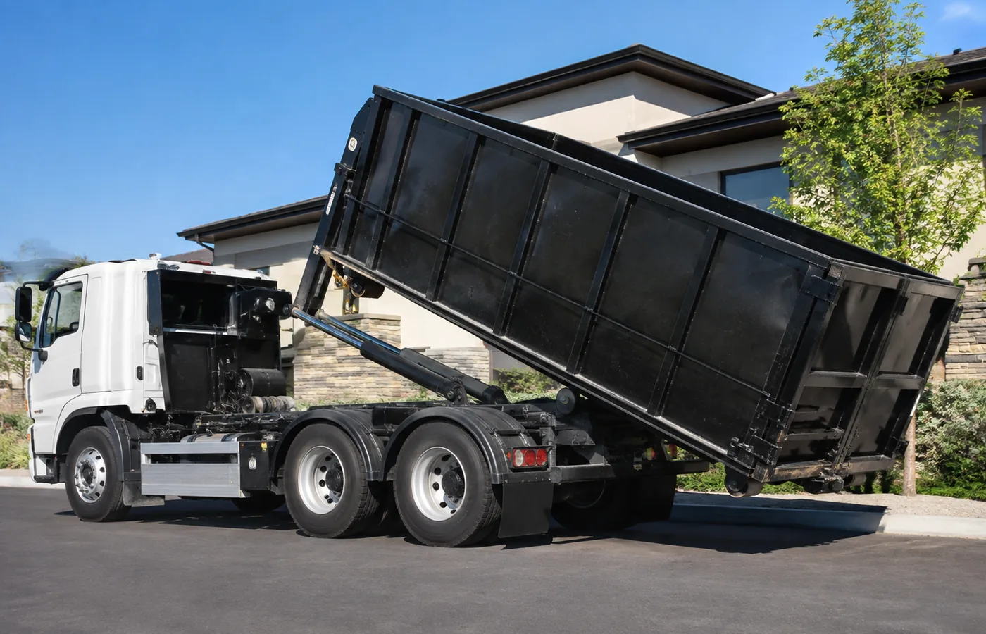 Workers loading a Roll-Off Dumpster at a Denver - CO remodel site before final cleanup, Crew loads a Roll-Off Dumpster at a Foxfield - CO property during fencing and yard debris removal, Crew loading a Roll-Off Dumpster outside a Ken Caryl - CO property during renovation cleanup