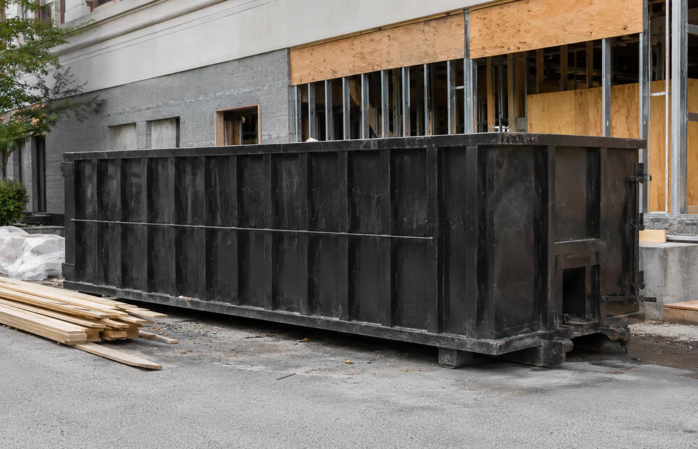Workers loading a Roll-Off Dumpster at an Acres Green - CO home during interior demolition cleanup, Workers fill a Roll-Off Dumpster at an Arvada - CO home during an organized exterior cleanup, Contractors loading a Roll-Off Dumpster at a Wheat Ridge - CO property during exterior demolition work